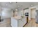 Kitchen island with granite counters, stainless sink, and pendant lights for a modern feel at 2090 Harvester Ln, Buford, GA 30518