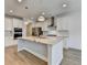 Modern kitchen features a granite island, stainless steel appliances and white cabinets at 2090 Harvester Ln, Buford, GA 30518