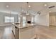 Open kitchen featuring an island with a stone countertop and stainless dishwasher at 2090 Harvester Ln, Buford, GA 30518