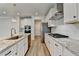 Well-lit kitchen features stainless appliances, shaker cabinets, gas range, and granite counters at 2090 Harvester Ln, Buford, GA 30518