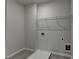 Laundry room with grey floors and utility sink connections at 2090 Harvester Ln, Buford, GA 30518