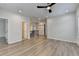 An open living room features wood-look floors, recessed lighting, and a ceiling fan at 2090 Harvester Ln, Buford, GA 30518