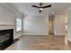 Bright living room with modern ceiling fan, fireplace and hardwood floors at 2090 Harvester Ln, Buford, GA 30518