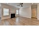 Cozy living room with a modern fireplace, large windows, and sleek ceiling fan at 2090 Harvester Ln, Buford, GA 30518