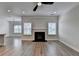 Inviting living room with hardwood floors, modern fan, and fireplace at 2090 Harvester Ln, Buford, GA 30518