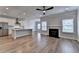 Bright, open living space featuring a kitchen island, fireplace, and stainless steel appliances at 2090 Harvester Ln, Buford, GA 30518