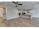 Open floor plan showcasing the modern kitchen and hardwood floors at 2090 Harvester Ln, Buford, GA 30518