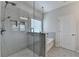 Main bathroom featuring tiled walk in shower with glass door and tub at 2090 Harvester Ln, Buford, GA 30518