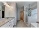 Main bathroom featuring a walk in shower, and double sinks with granite counters at 2090 Harvester Ln, Buford, GA 30518
