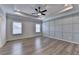 Spacious main bedroom with tray ceilings, recessed lighting, a ceiling fan and wood floors at 2090 Harvester Ln, Buford, GA 30518