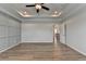 Large main bedroom with tray ceilings, ceiling fan and decorative wall trim at 2090 Harvester Ln, Buford, GA 30518