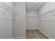 Walk-in closet with wire shelving and wood-look floors at 2090 Harvester Ln, Buford, GA 30518