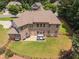 Aerial view of a large brick home with a spacious backyard and lush landscaping at 3315 High Noontide Nw Way, Acworth, GA 30101