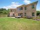 Brick home with a spacious backyard featuring a patio and lush green grass at 3315 High Noontide Nw Way, Acworth, GA 30101