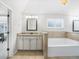 Bright bathroom featuring a soaking tub, double vanities, and tile flooring at 3315 High Noontide Nw Way, Acworth, GA 30101