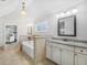Bright bathroom featuring a soaking tub, double vanities, and tile flooring, leading to the Primary bedroom at 3315 High Noontide Nw Way, Acworth, GA 30101