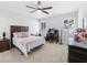 Cozy bedroom with a ceiling fan, a wooden bed frame, and windows with plantation shutters at 3315 High Noontide Nw Way, Acworth, GA 30101
