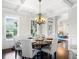 Elegant dining room featuring a coffered ceiling, hardwood floors, and a stylish chandelier over the wood table at 3315 High Noontide Nw Way, Acworth, GA 30101