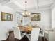 Elegant dining room with coffered ceilings, wainscoting, a round table and views to the backyard at 3315 High Noontide Nw Way, Acworth, GA 30101