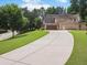 Two-story brick home featuring a long driveway and attached garage at 3315 High Noontide Nw Way, Acworth, GA 30101