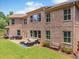 Brick home showcasing its well-manicured lawn, patio seating, and established landscaping at 3315 High Noontide Nw Way, Acworth, GA 30101