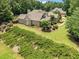 Brick home featuring a well-manicured lawn and lush landscaping at 3315 High Noontide Nw Way, Acworth, GA 30101