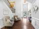 Bright foyer with hardwood flooring, two chairs, staircase, decor, and front door view at 3315 High Noontide Nw Way, Acworth, GA 30101