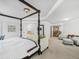 Main bedroom with a canopy bed, sitting area, and doorway view of a staircase and hall at 3315 High Noontide Nw Way, Acworth, GA 30101