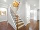 Elegant staircase with hardwood treads, decorative iron railings, and natural light at 3315 High Noontide Nw Way, Acworth, GA 30101
