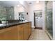Bathroom featuring granite countertops, double sinks, and a glass-enclosed shower at 400 17Th St # 2325, Atlanta, GA 30363