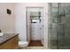 The bathroom has a glass shower and walk-in closet, plus a granite countertop vanity at 400 17Th St # 2325, Atlanta, GA 30363