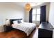 Comfortable bedroom with hardwood floors, a bed and modern lighting fixture at 400 17Th St # 2325, Atlanta, GA 30363