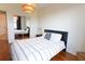 A furnished bedroom with hardwood floors, a bed, and a mirrored closet at 400 17Th St # 2325, Atlanta, GA 30363