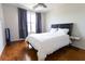 Cozy bedroom with hardwood flooring, a comfortable bed, and a large window providing natural light at 400 17Th St # 2325, Atlanta, GA 30363