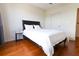 Cozy bedroom features hardwood floors, neutral walls, and a comfortable queen-sized bed at 400 17Th St # 2325, Atlanta, GA 30363