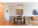 Bright dining area with hardwood floors, stylish lighting fixture, and seating for four at 400 17Th St # 2325, Atlanta, GA 30363