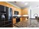 Bright kitchen boasting granite countertops, stainless steel appliances, and light wood cabinetry at 400 17Th St # 2325, Atlanta, GA 30363