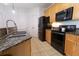 Well-equipped kitchen with granite countertops, stainless steel appliances, and tile flooring at 400 17Th St # 2325, Atlanta, GA 30363