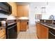 Well-lit kitchen features granite countertops, stainless steel appliances, and light wood cabinetry at 400 17Th St # 2325, Atlanta, GA 30363