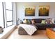 Comfortable living room with a large window and a stylish brown sectional sofa at 400 17Th St # 2325, Atlanta, GA 30363