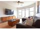 Relaxing living room featuring a large sectional sofa, natural light and a television at 400 17Th St # 2325, Atlanta, GA 30363