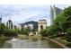 Scenic pond with a fountain surrounded by lush landscaping and residential buildings at 400 17Th St # 2325, Atlanta, GA 30363