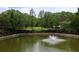 An above-ground view of a large pond with green water and a fountain in the middle at 400 17Th St # 2325, Atlanta, GA 30363