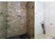 A stylish tiled shower features a glass door, built-in niche, and modern fixtures at 400 17Th St # 2325, Atlanta, GA 30363