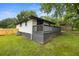 Large, grassy backyard featuring a wooden fence and a gray deck at 1553 Mccallie Nw Blvd, Atlanta, GA 30318