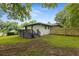 Large, grassy backyard featuring a wooden fence and a gray deck at 1553 Mccallie Nw Blvd, Atlanta, GA 30318