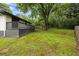 Large, grassy backyard featuring a wooden fence and a gray deck at 1553 Mccallie Nw Blvd, Atlanta, GA 30318