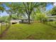 Large, grassy backyard featuring a wooden fence and a gray deck at 1553 Mccallie Nw Blvd, Atlanta, GA 30318