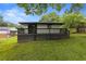 Large, grassy backyard featuring a wooden fence and a gray deck at 1553 Mccallie Nw Blvd, Atlanta, GA 30318