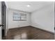 Clean bedroom with hardwood floors, a window, and closet space, offering a cozy retreat at 1553 Mccallie Nw Blvd, Atlanta, GA 30318